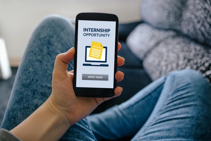 Image of person holding a phone with "internship opportunity" text