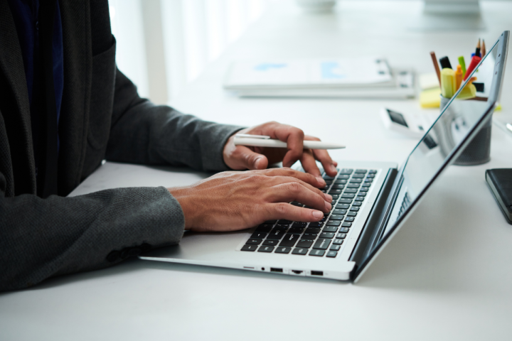 A person types on a computer